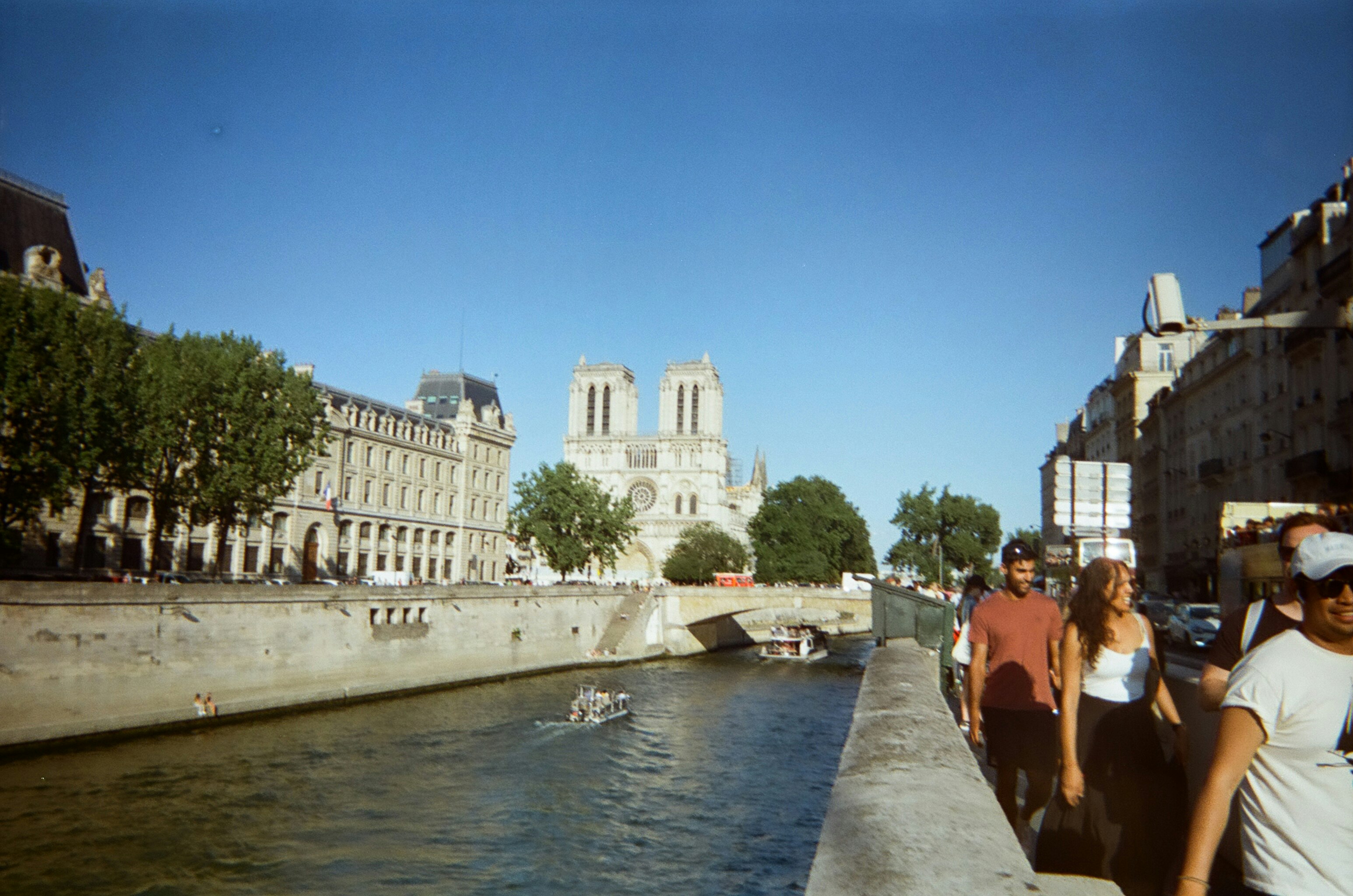 people walking on concrete bridge near white concrete building during daytime